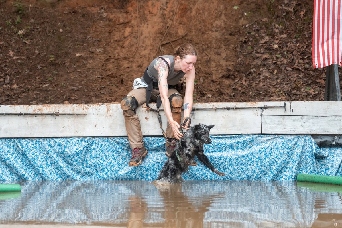 Dr. C placing Grim inthe pool ahead of her