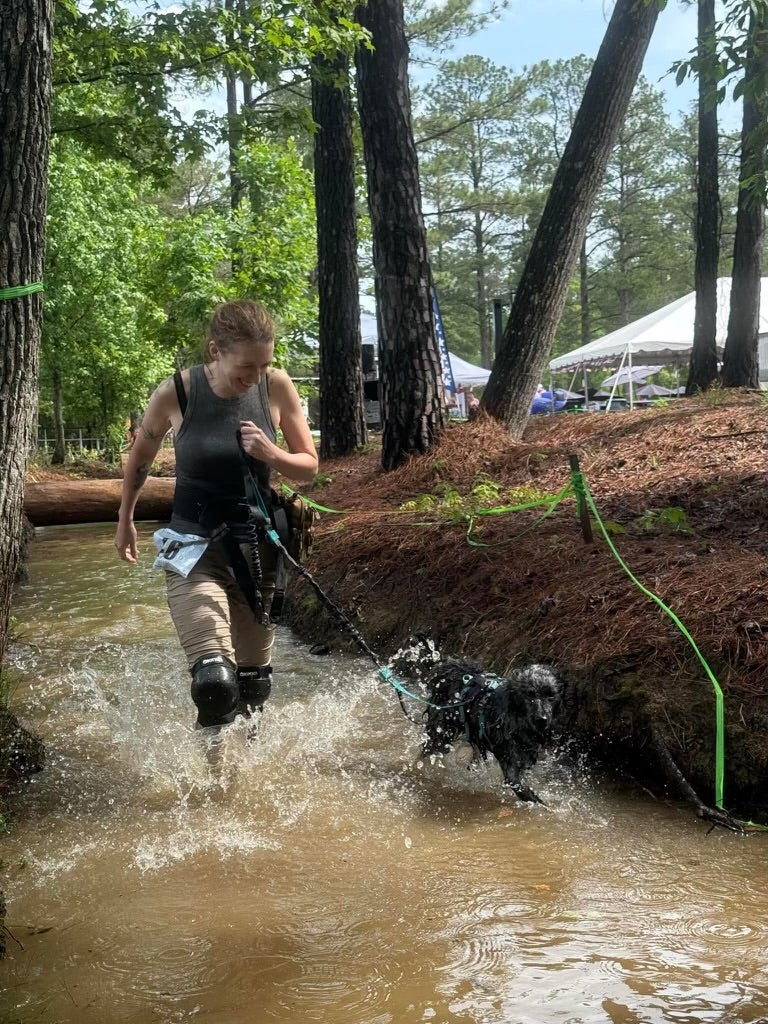Dr. C running in the water with Grim